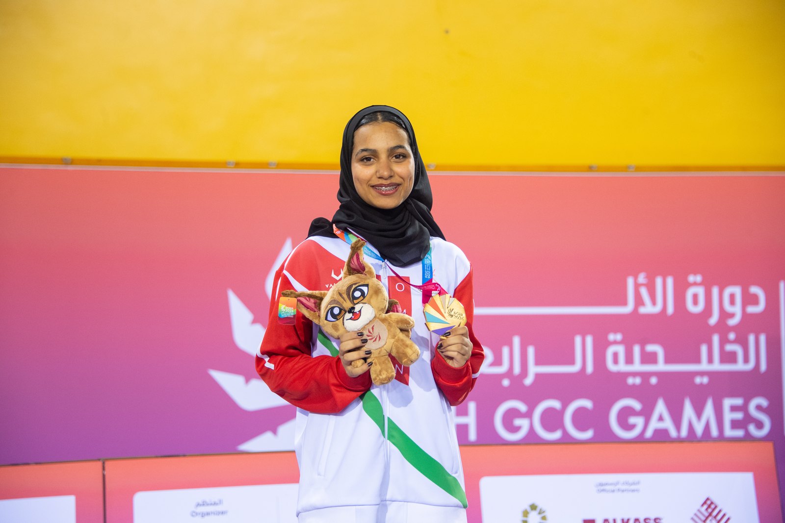 Israa Al Siyabi receiving her gold medal on the top step of the women's individual épée podium at the 4th GCC Games in Doha